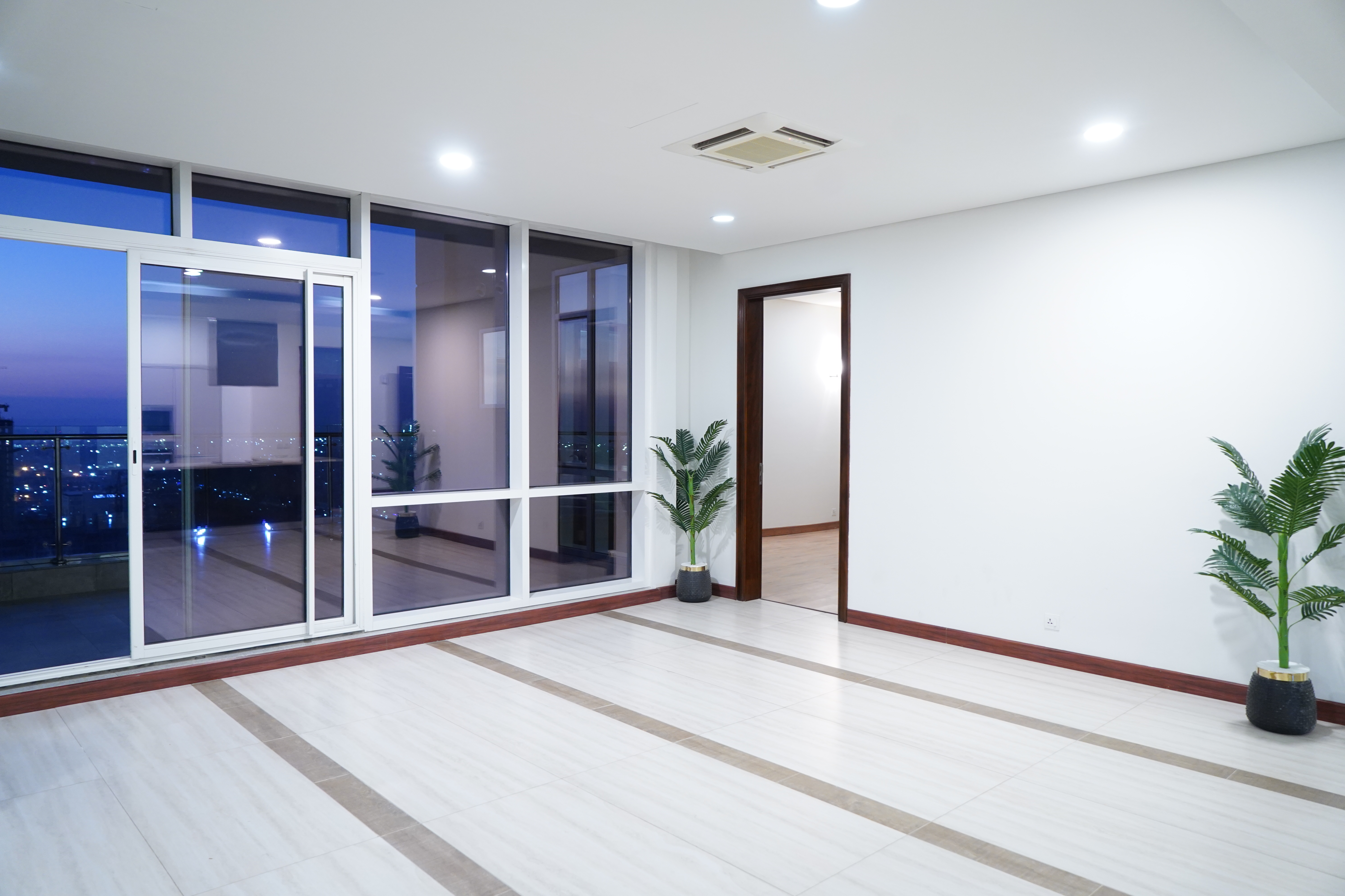 Finished interior with evening city view at Summit Tower